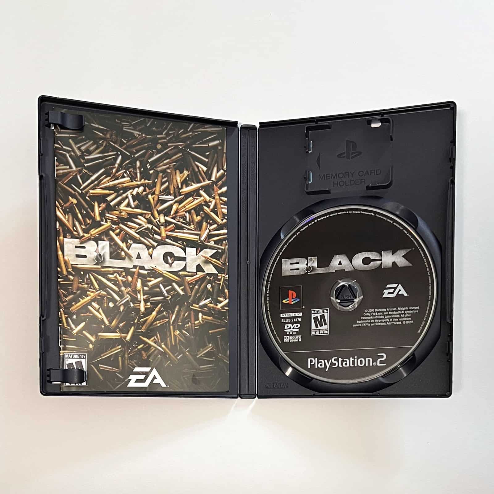 Black PS2 case open with disc and manual