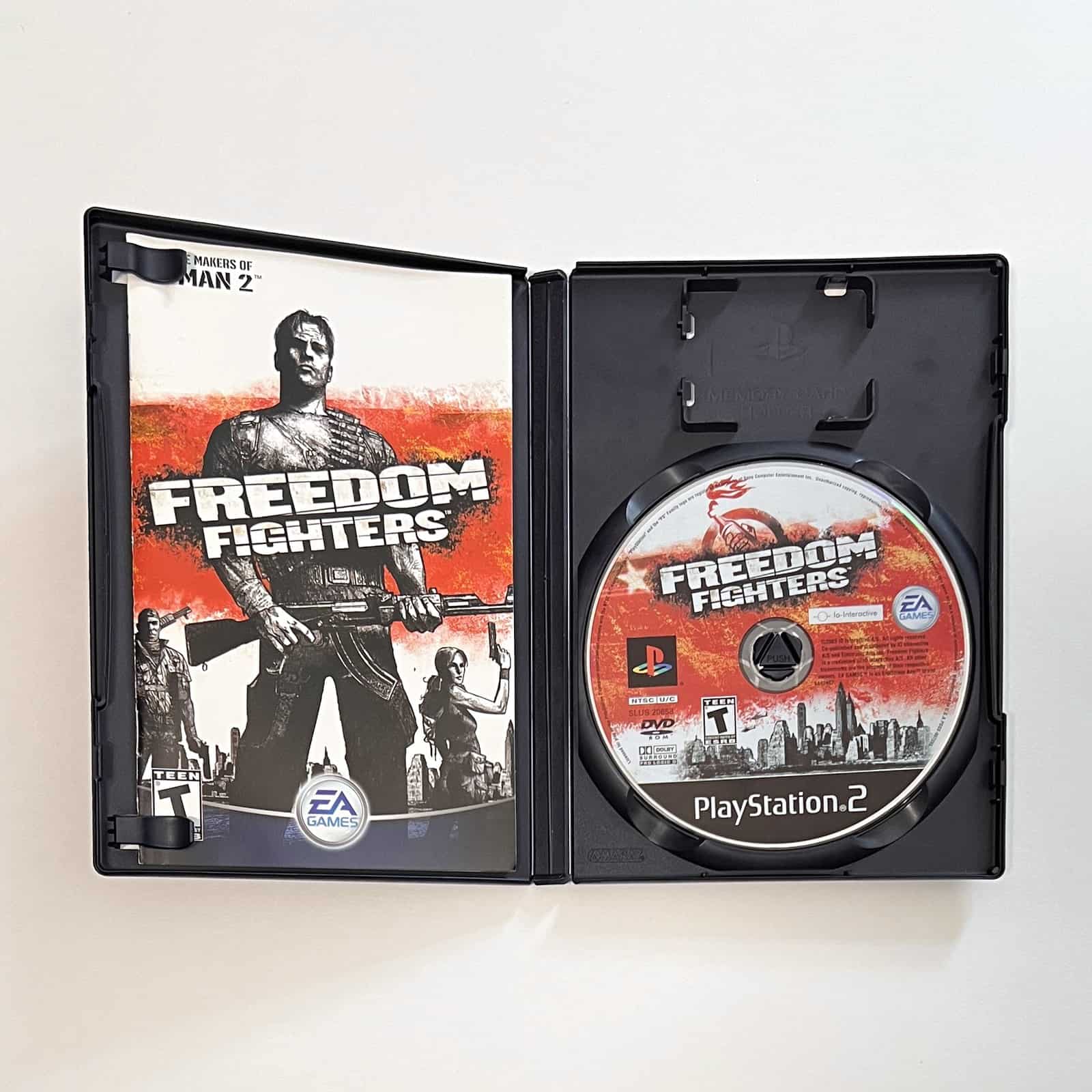 Freedom Fighters PS2 case open with disc and manual
