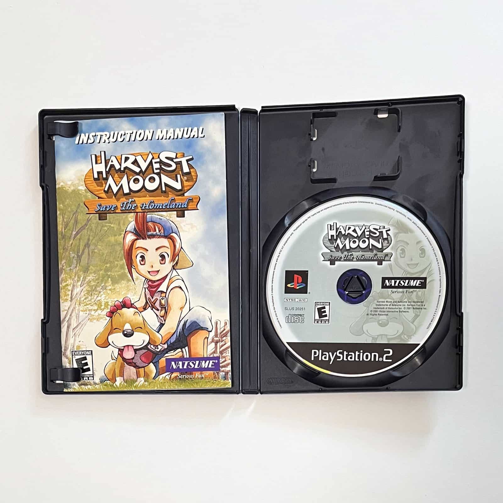 Harvest Moon: Save the Homeland PS2 case open with disc and manual